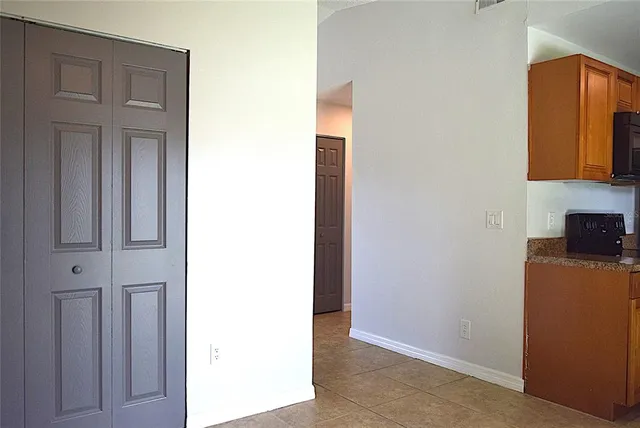 a kitchen with stainless steel appliances granite countertop a stove microwave and refrigerator