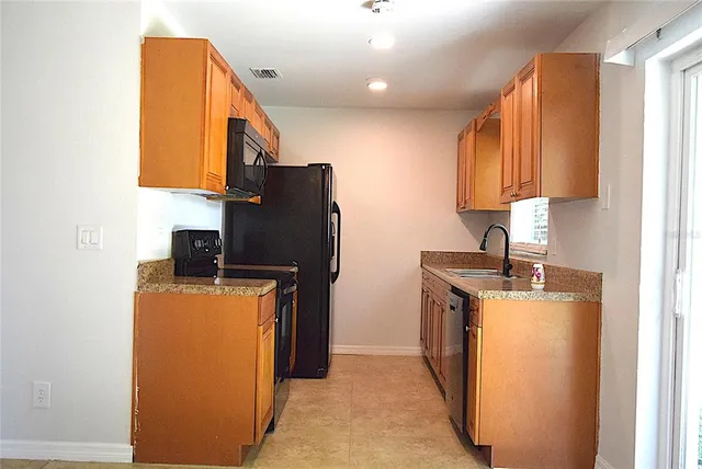 a kitchen with stainless steel appliances granite countertop a sink and a cabinets
