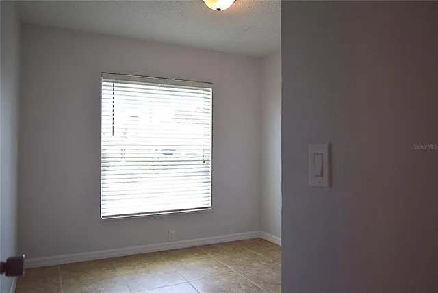 a view of a backyard with a tree and wooden fence