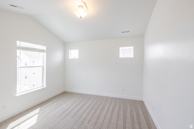 693 West 4500th South, Unit O304 Mapleton, UT 84664 - Photo 10 of 16 Spare room featuring light colored carpet and vaulted ceiling