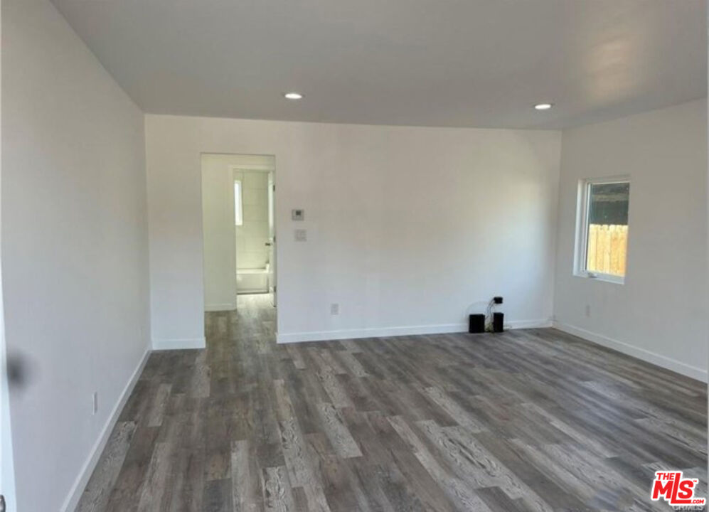 328 West Elm Street Compton, CA 90220 - Photo 2 of 12 a view of a big room with wooden floor and windows