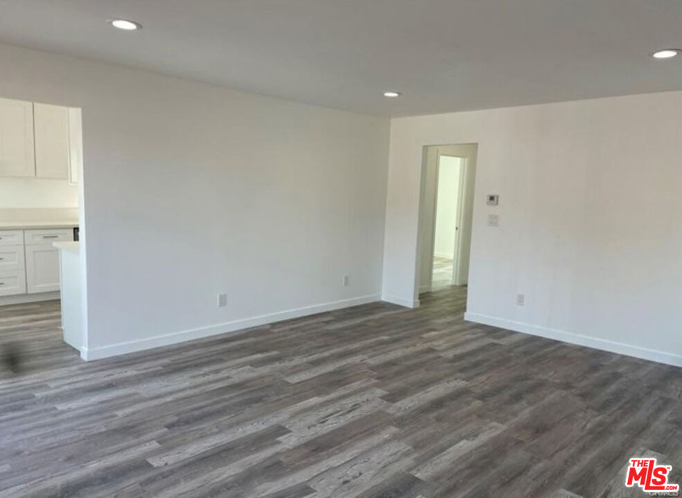 328 West Elm Street Compton, CA 90220 - Photo 3 of 12 a view of an empty room with wooden floor