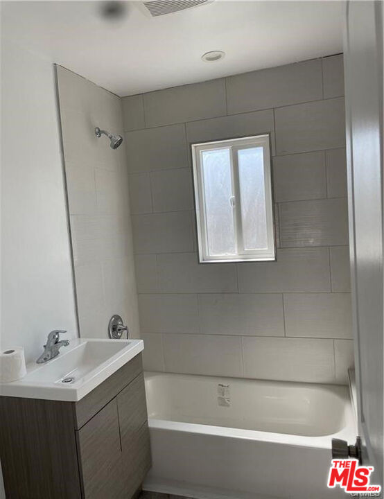 328 West Elm Street Compton, CA 90220 - Photo 8 of 12 a bathroom with a bathtub and a sink