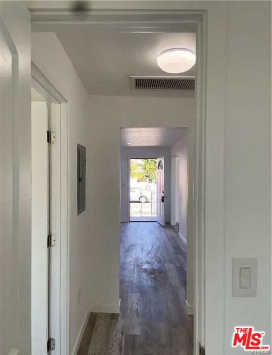 328 West Elm Street Compton, CA 90220 - Photo 9 of 12 a view of a hallway with wooden floor and a chandelier