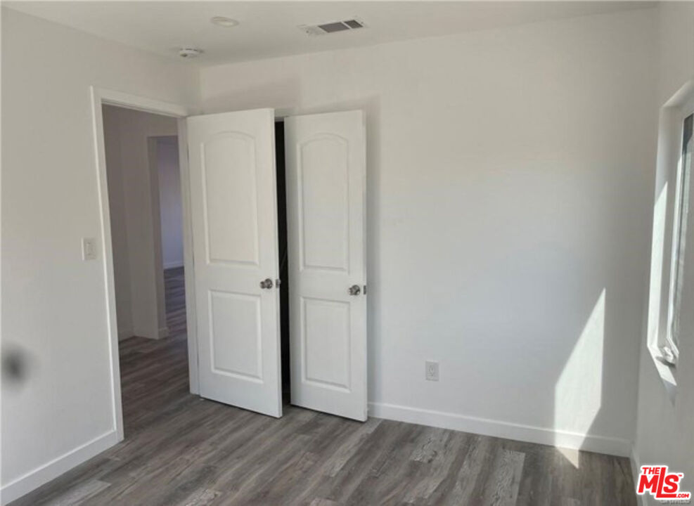 328 West Elm Street Compton, CA 90220 - Photo 10 of 12 a view of hallway with wooden floor