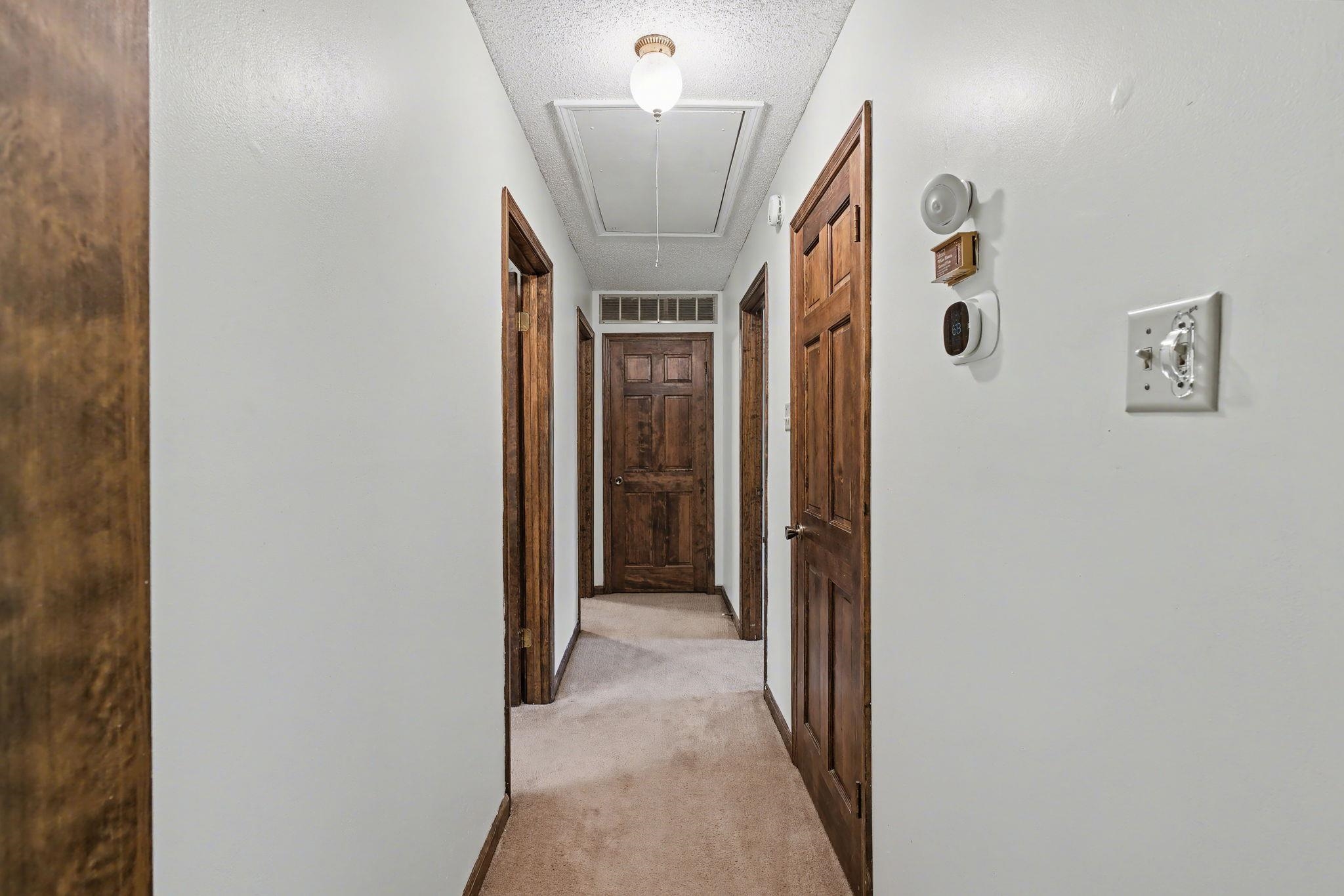 11380 Sycamore Farms Road Collierville, TN 38017 - Photo 22 of 38 Hallway featuring light colored carpet and a textured ceiling