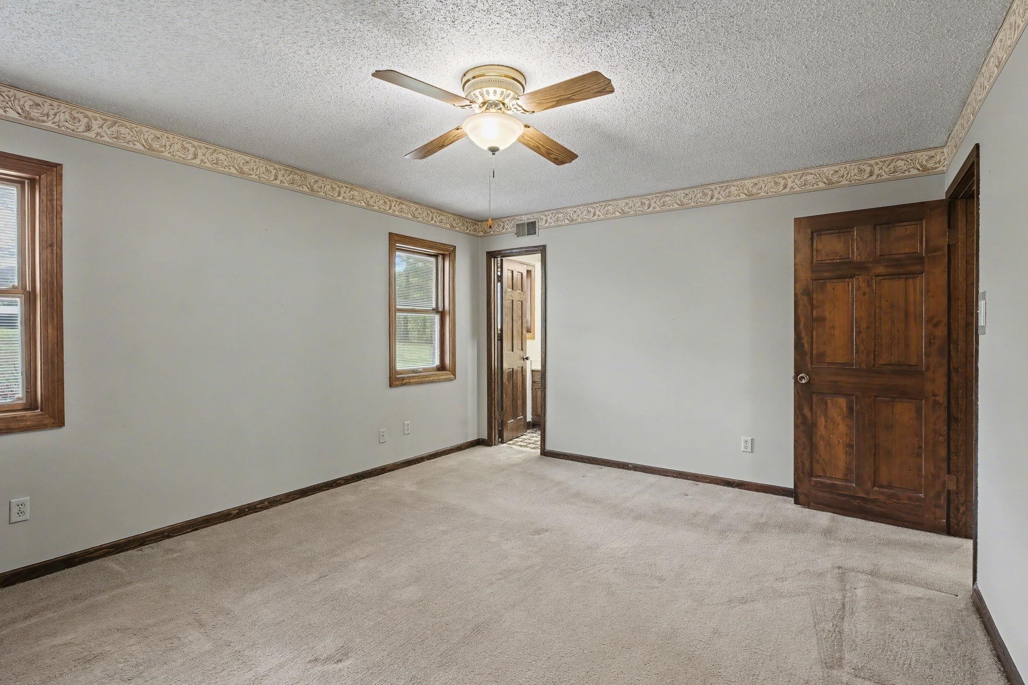 11380 Sycamore Farms Road Collierville, TN 38017 - Photo 24 of 38 Unfurnished room with a ceiling fan, light carpet, and a textured ceiling