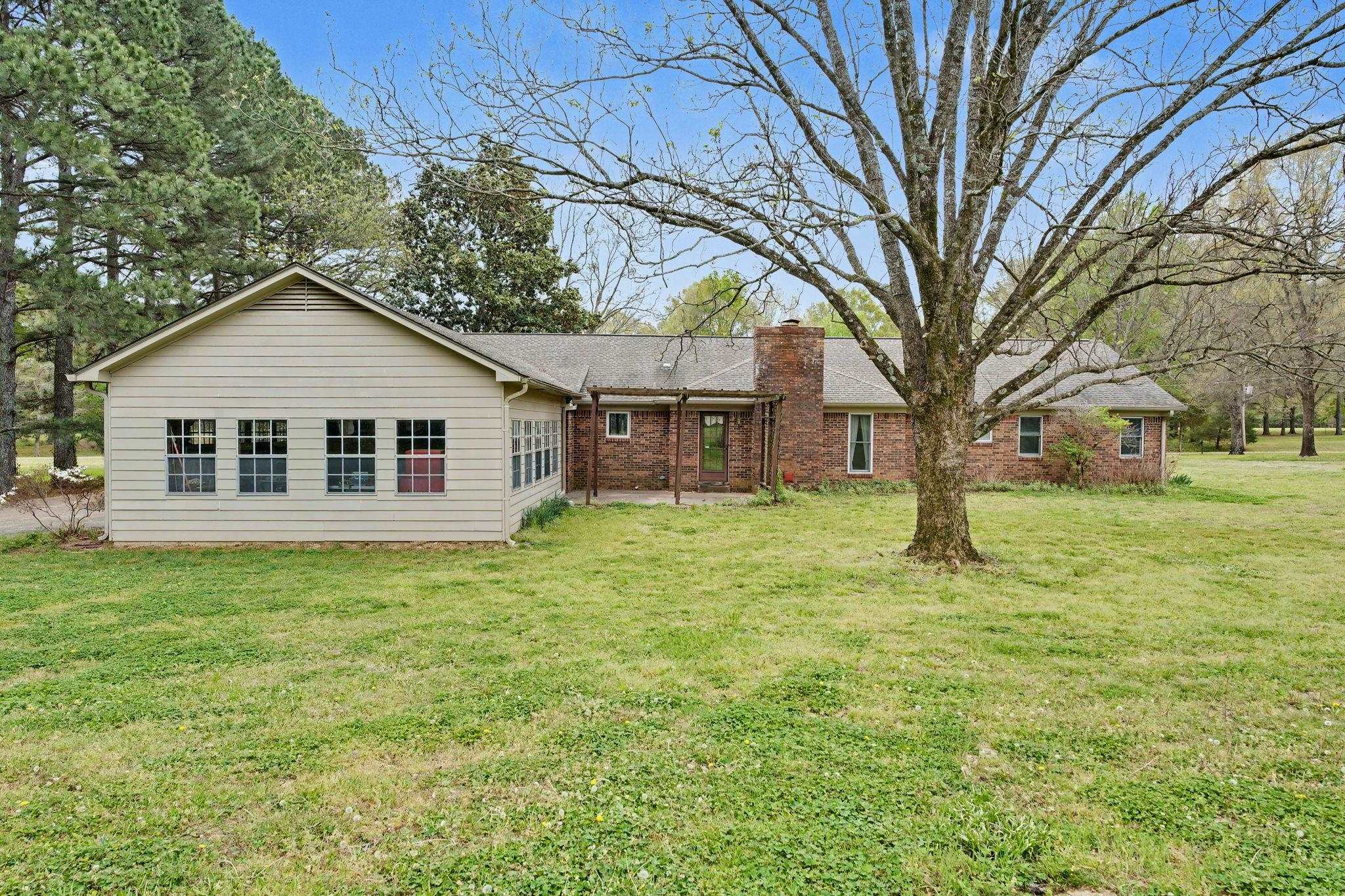 11380 Sycamore Farms Road Collierville, TN 38017 - Photo 31 of 38 Rear view of property with a patio, a lawn, a chimney, and brick siding