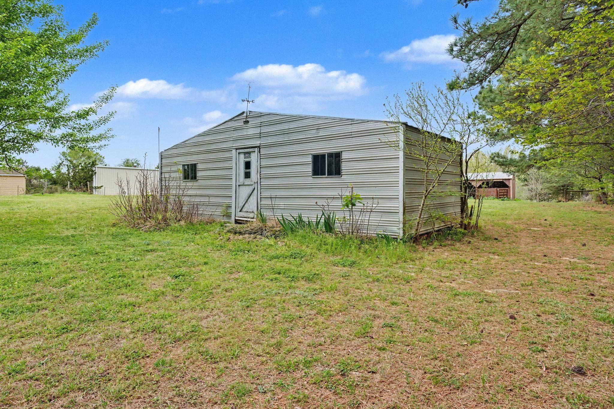 11380 Sycamore Farms Road Collierville, TN 38017 - Photo 33 of 38 Back of house featuring a lawn and an outbuilding