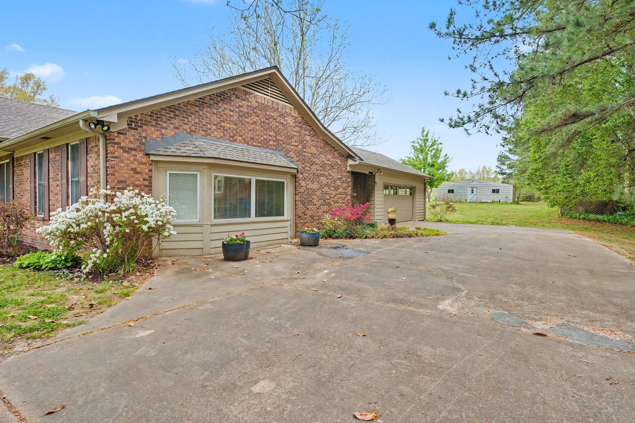 11380 Sycamore Farms Road Collierville, TN 38017 - Photo 5 of 38 View of front of house featuring brick siding, an attached garage, concrete driveway, and a shingled roof