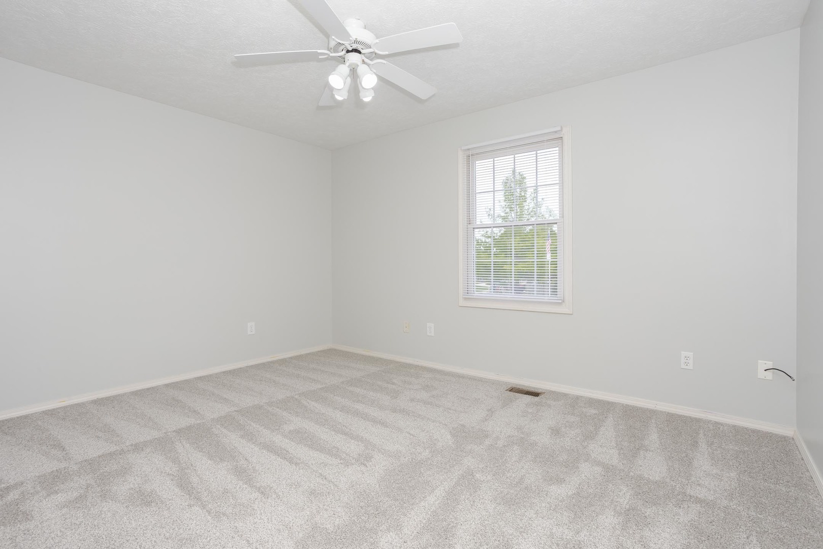 814 Landau Lane Normal, IL 61761 - Photo 41 of 58 an empty room with a window and a fan