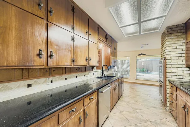 a large kitchen with kitchen island a sink a counter and a large window