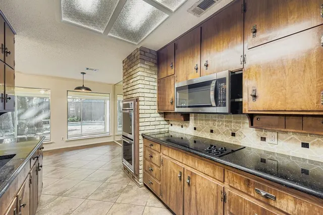a bathroom with a sink a large mirror and a bathtub