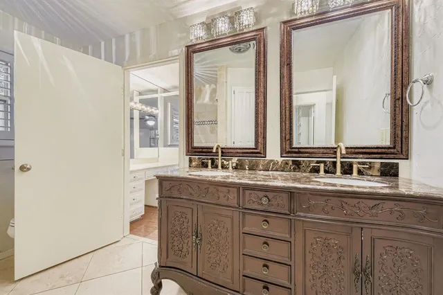 a bathroom with a double vanity sink and mirror