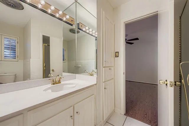 a bathroom with a double vanity sink mirror and shower