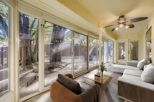 a living room with furniture and a floor to ceiling window