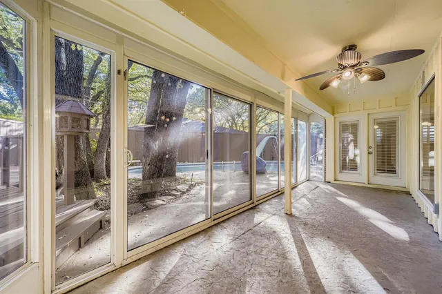 a view of a big room with balcony furniture and floor to ceiling window