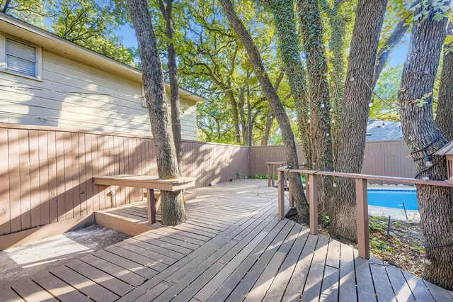 a view of balcony with wooden floor and outdoor seating