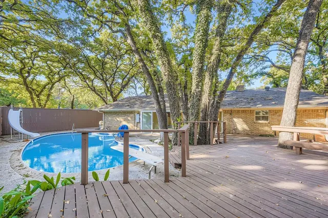 a view of a patio with table and chairs and wooden floor