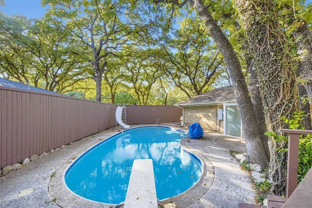 a view of swimming pool from a backyard