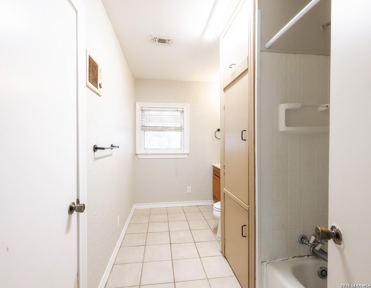 149 South Carroll Street Poth, TX 78147 - Photo 17 of 28 a bathroom with a tub and shower