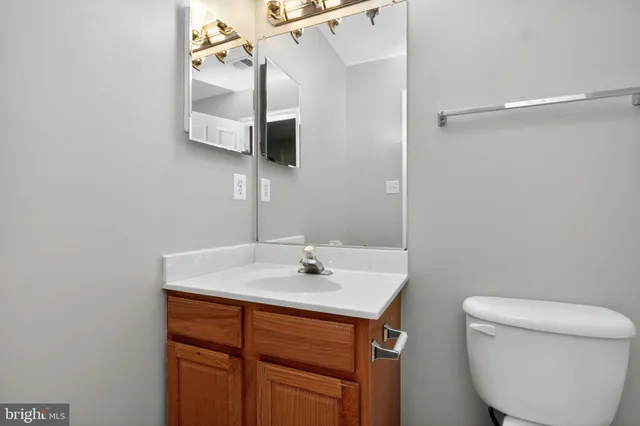 a bathroom with a sink toilet and mirror