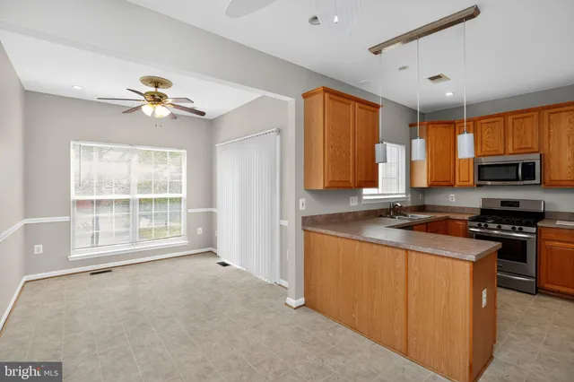 a view of a kitchen with microwave and windows