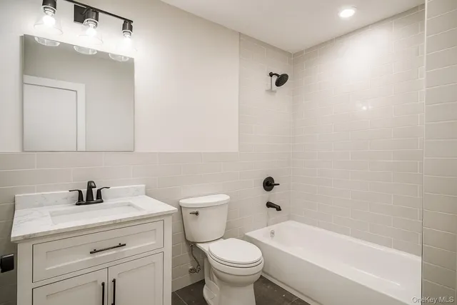 a bathroom with a sink a toilet and a bathtub