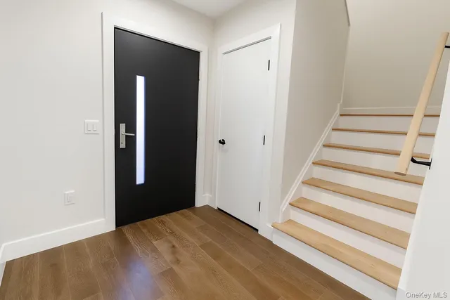 a view of kitchen with kitchen island wooden floor center island and stainless steel appliances