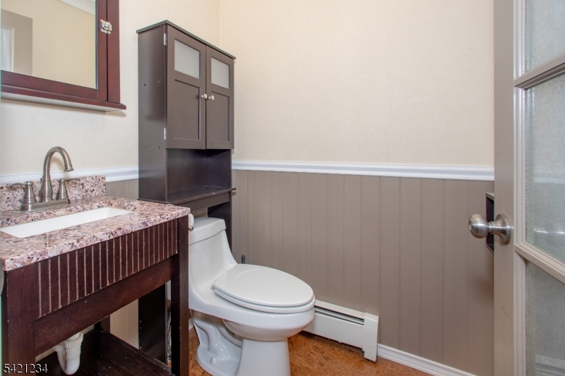 105 Valley Road Wantage, NJ 07461 - Photo 14 of 32 a bathroom with a granite countertop toilet sink and mirror