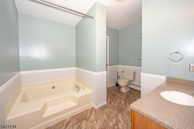 105 Valley Road Wantage, NJ 07461 - Photo 17 of 32 a bathroom with a bathtub and a toilet