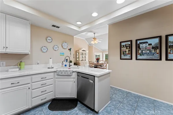 a kitchen with a sink cabinets and wooden floor