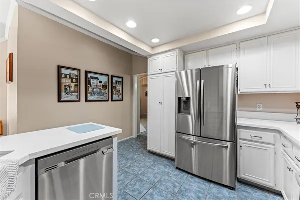 a kitchen with stainless steel appliances a refrigerator sink and microwave