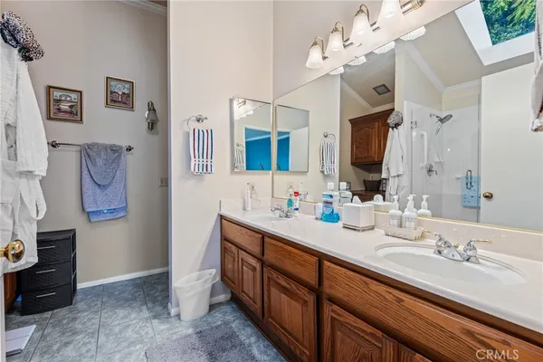 a spacious bathroom with a double vanity sink mirror and chandelier