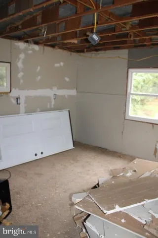 a room with a wooden floor and a window