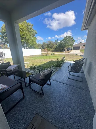 a view of swimming pool with outdoor seating and ocean view