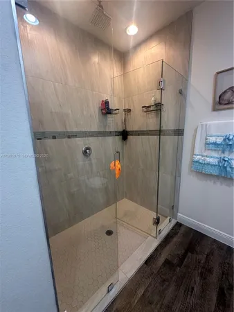 a bathroom with a shower and a sink
