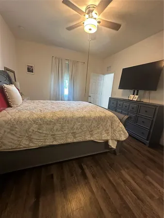 a bedroom with a bed and flat screen tv