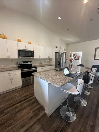 a kitchen with sink cabinets and dining table