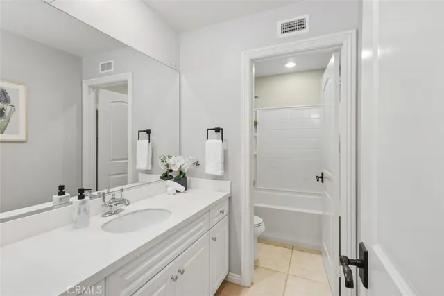 a bathroom with a double vanity sink mirror and double