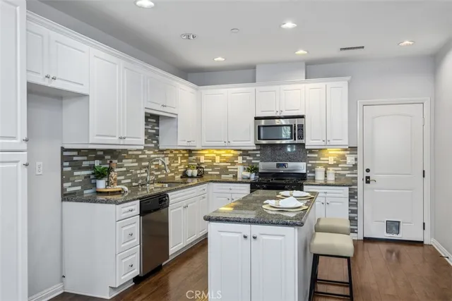 a kitchen with a stove a microwave and refrigerator