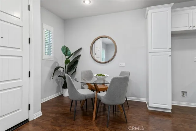 a dining room with furniture and wooden floor