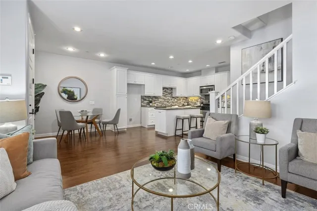 a living room with lots of furniture and kitchen view