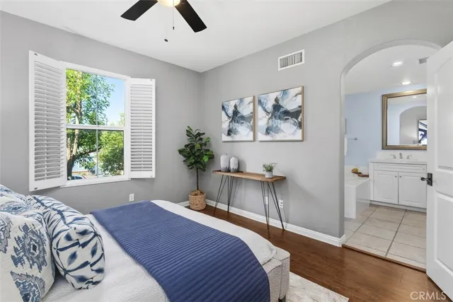 a bedroom with a bed and a chandelier