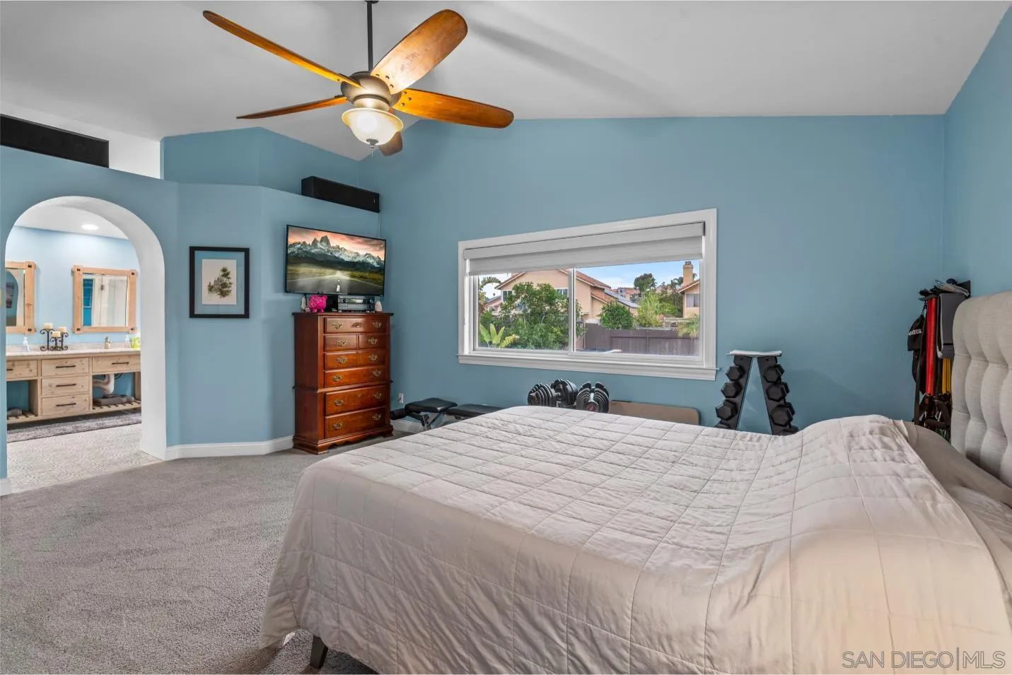 9342 Parus Point San Diego, CA 92129 - Photo 20 of 44 a bedroom with a bed and a chandelier