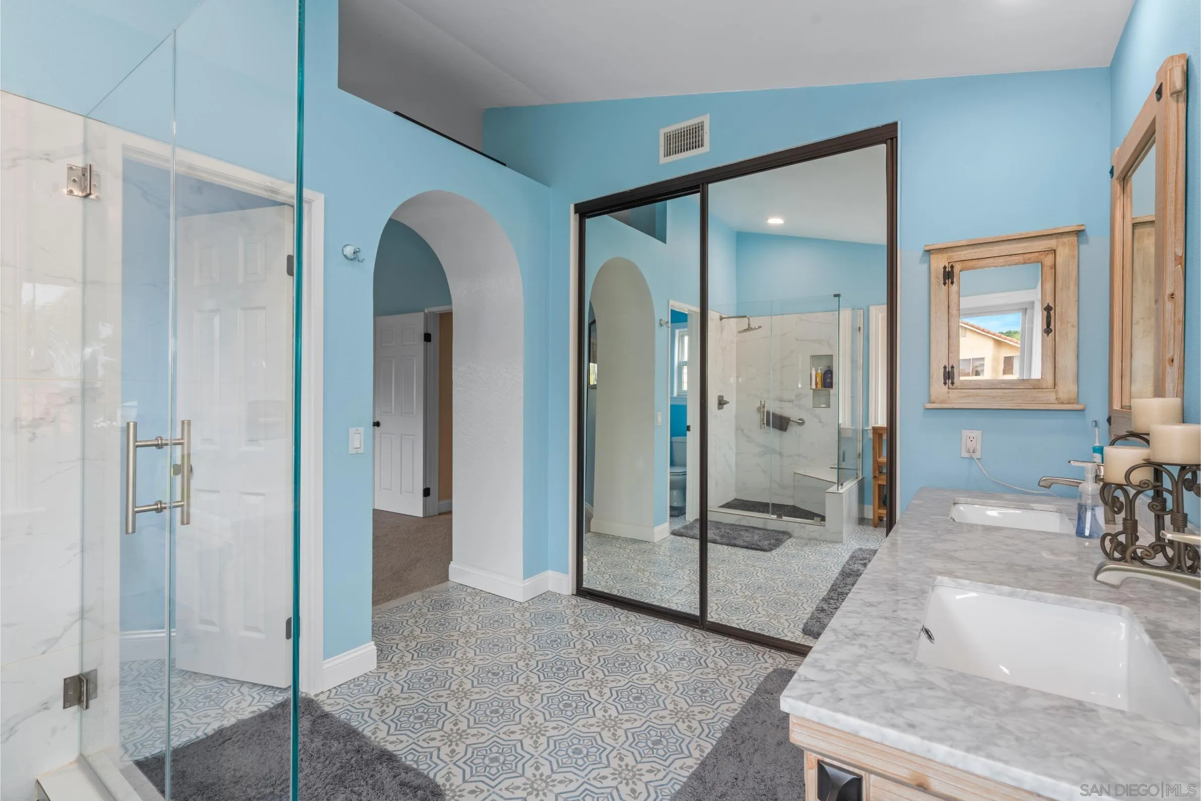 9342 Parus Point San Diego, CA 92129 - Photo 21 of 44 a view of a bathroom with tub shower and mirror