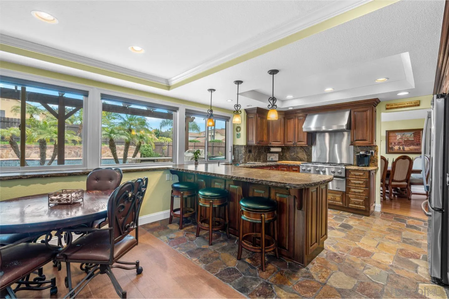 9342 Parus Point San Diego, CA 92129 - Photo 9 of 44 a kitchen with a table and chairs in it