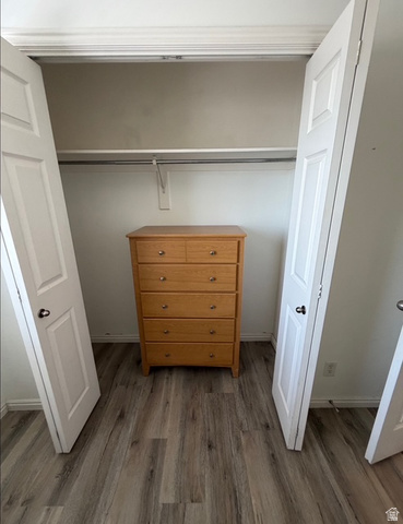 72 300 North, Unit 302 Provo, UT 84601 - Photo 16 of 16 Closet space featuring wood-finish flooring, white bi-fold doors, and a built-in hanging rod