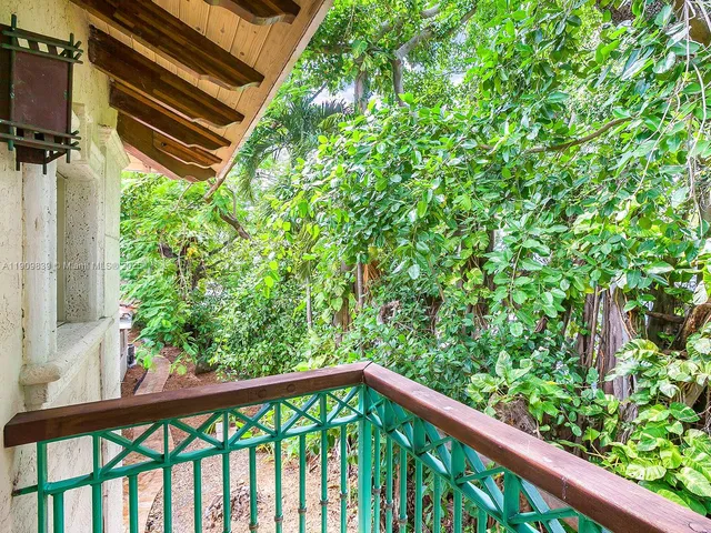 a backyard of a house with wooden floor plants and outdoor seating