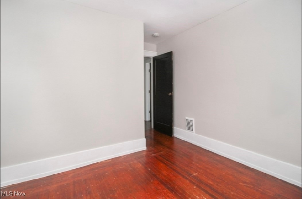 855 Roanoke Road Cleveland Heights, OH 44121 - Photo 10 of 14 Unfurnished room featuring hardwood / wood-style flooring, baseboards, and visible vents
